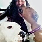 9c7eb92eaf6fb74b1a9a3f0abe2f1222 A woman with two dogs on a leash.