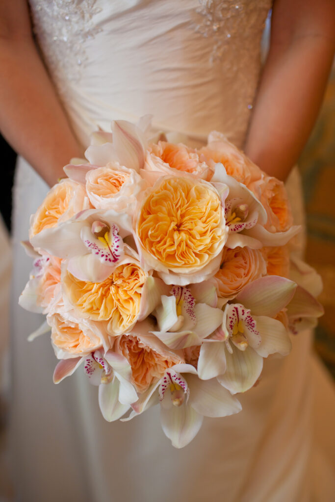 A bride holding her bouquet of flowers.