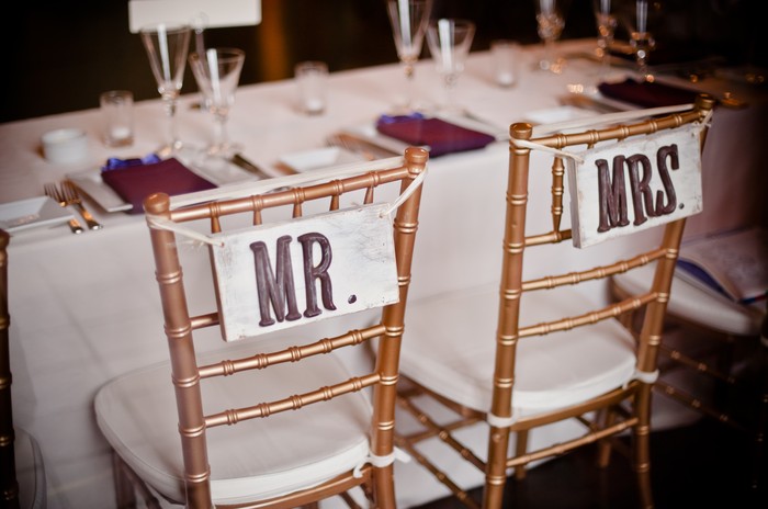 A table with two chairs and a white tablecloth