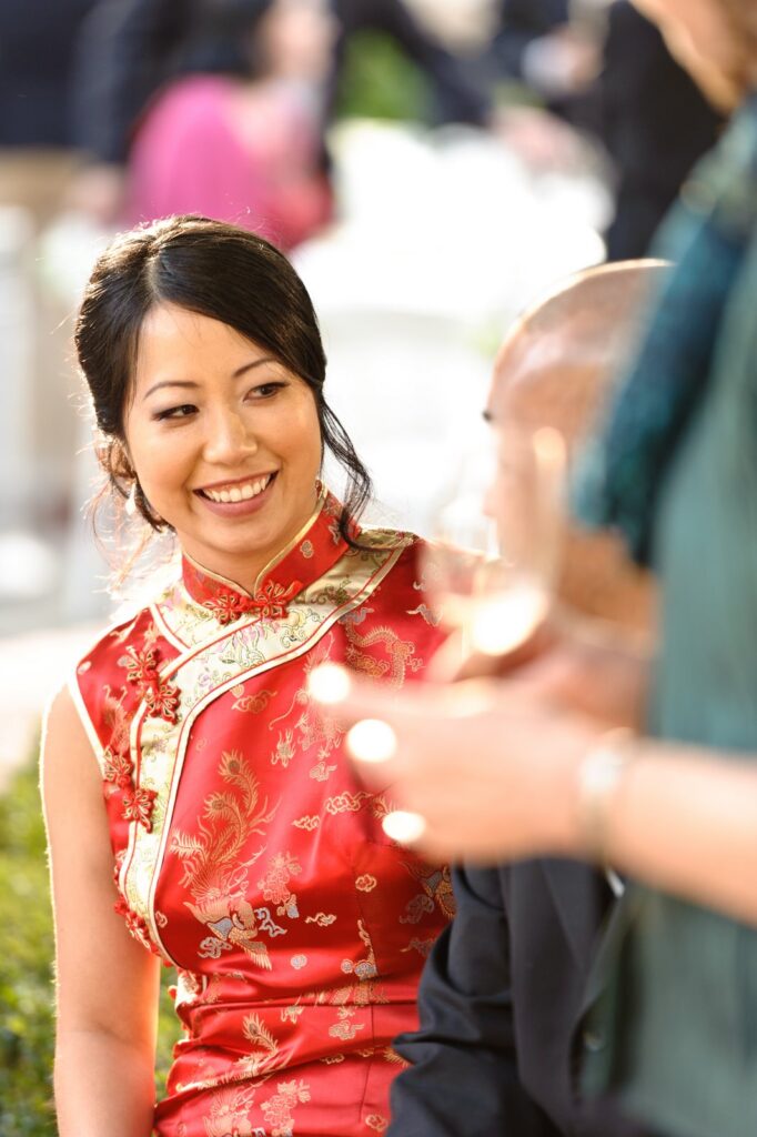 A woman in red is smiling at someone