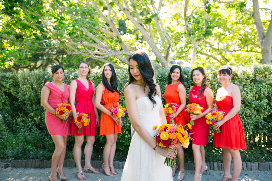 A bride and her bridesmaids in bright dresses