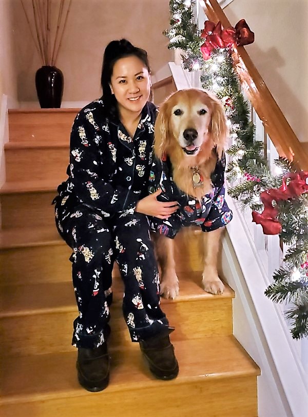 A woman and her dog sitting on the stairs.