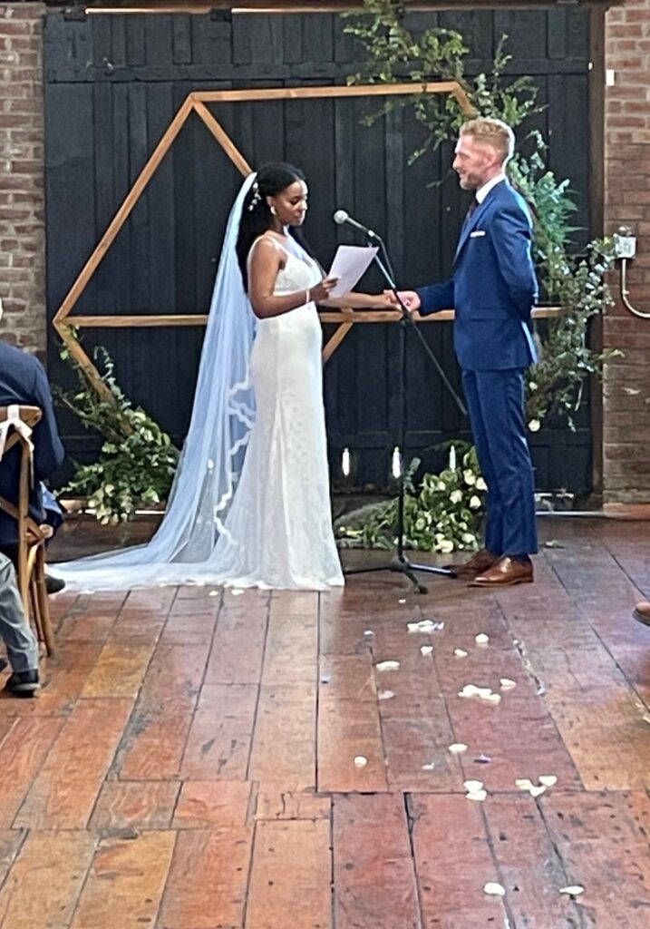 A couple getting married in front of an audience.