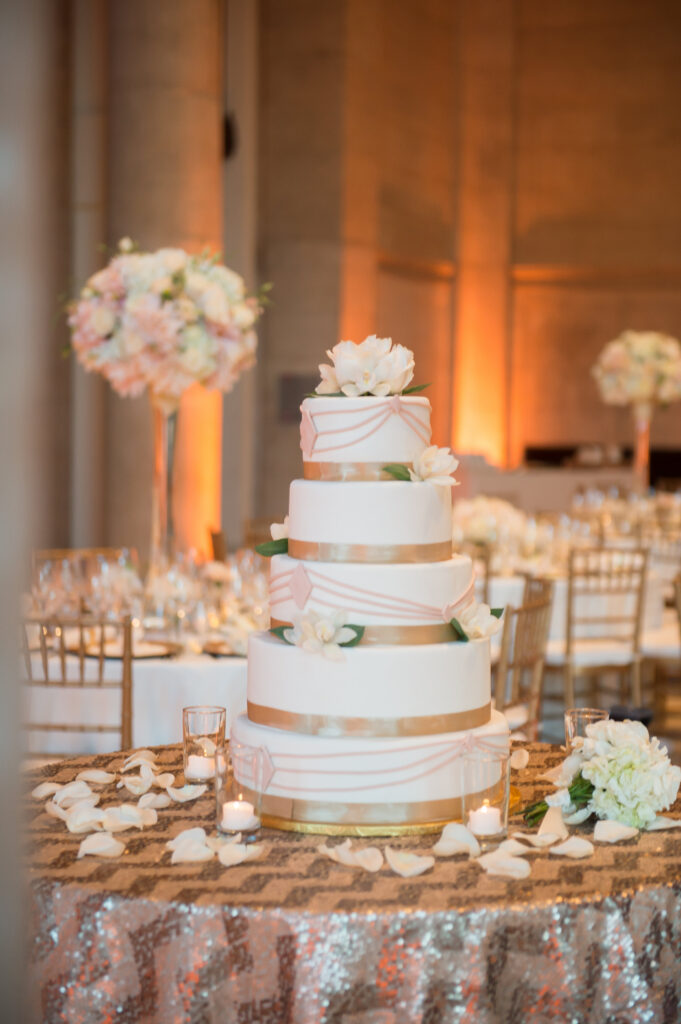 A wedding cake is sitting on the table.