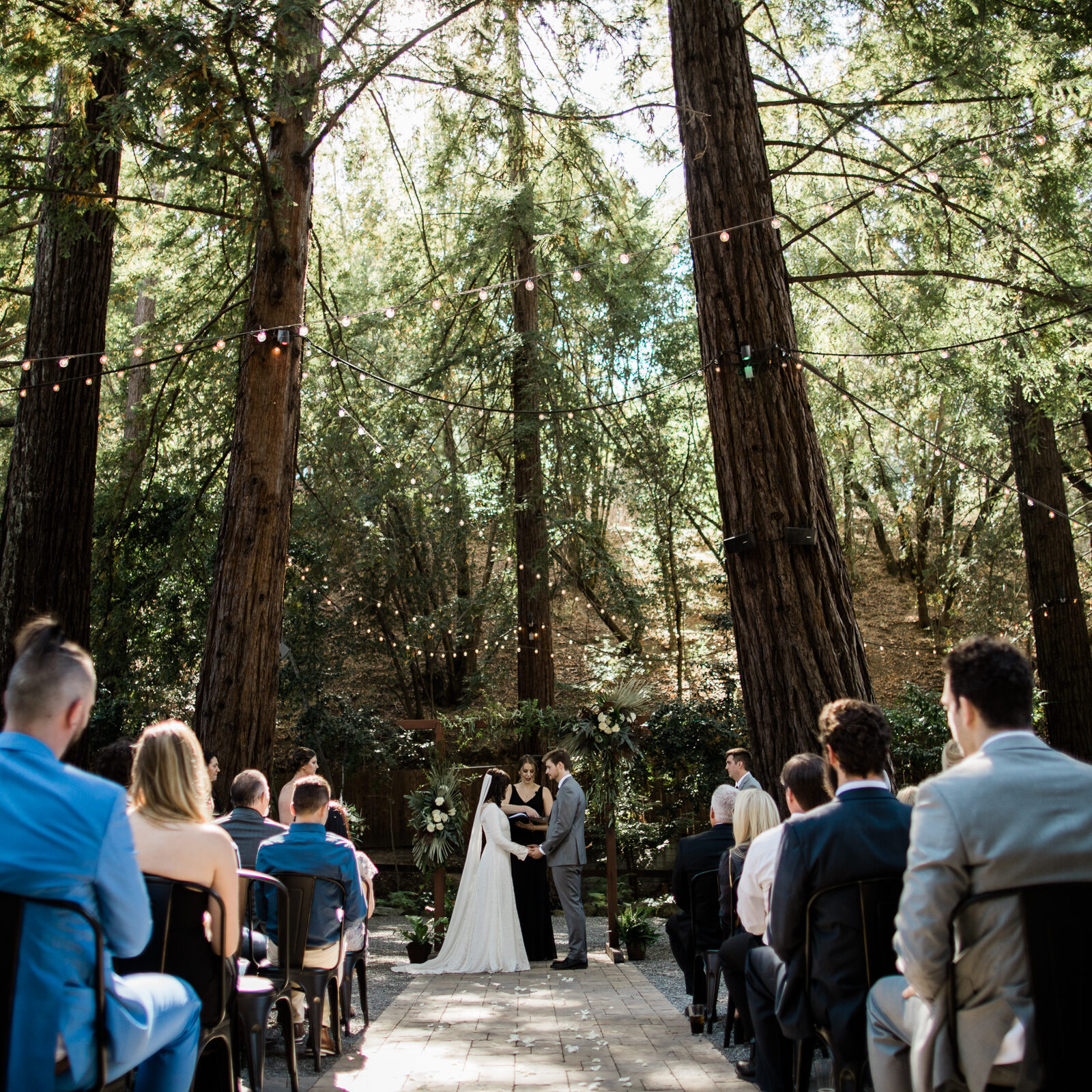 A couple is getting married in the woods