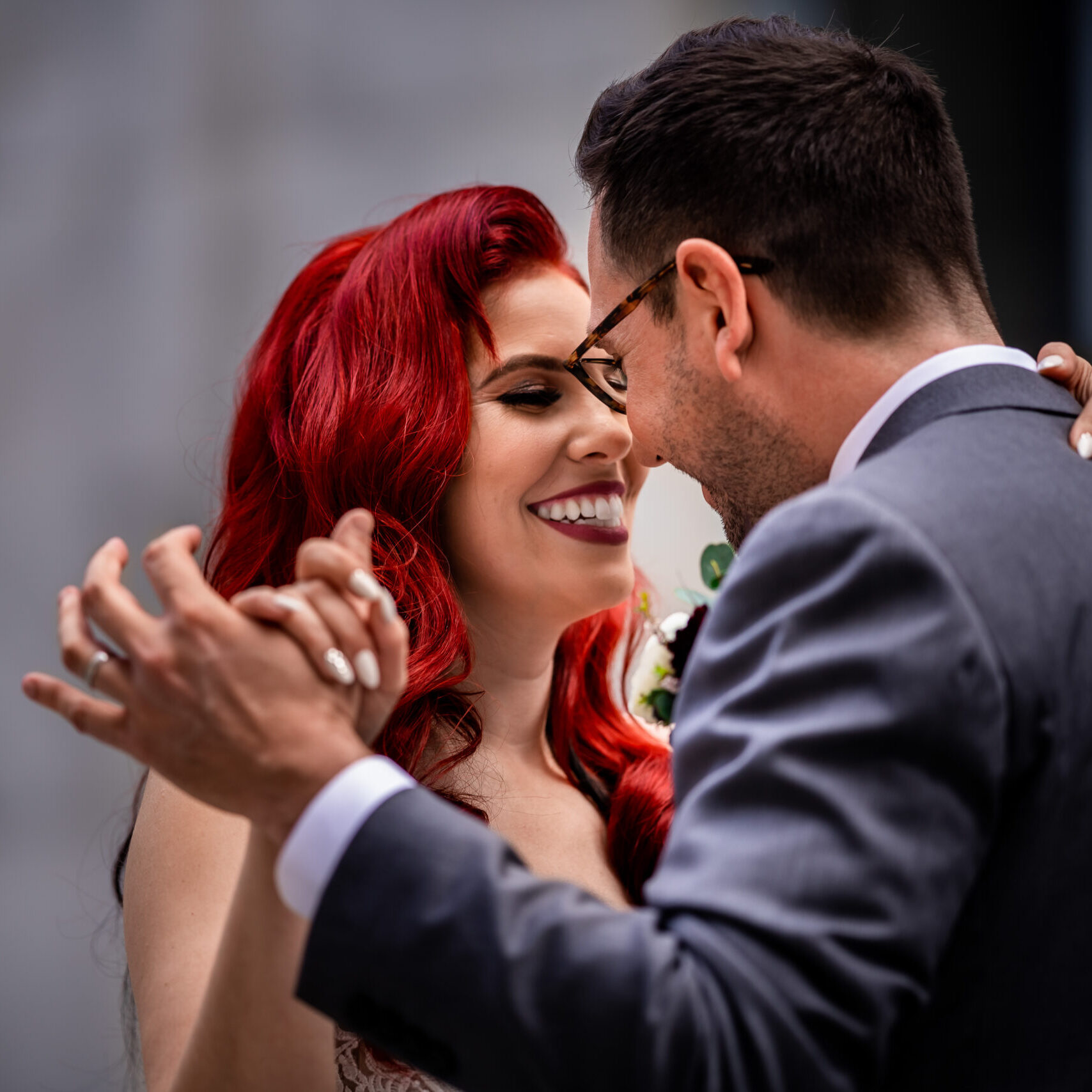 A man and woman dancing together in front of each other.