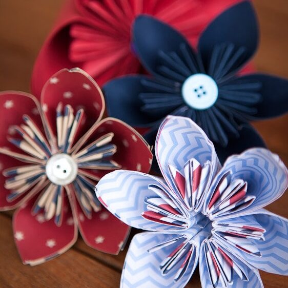 2-2-1 Paper flowers with buttons on wooden surface.