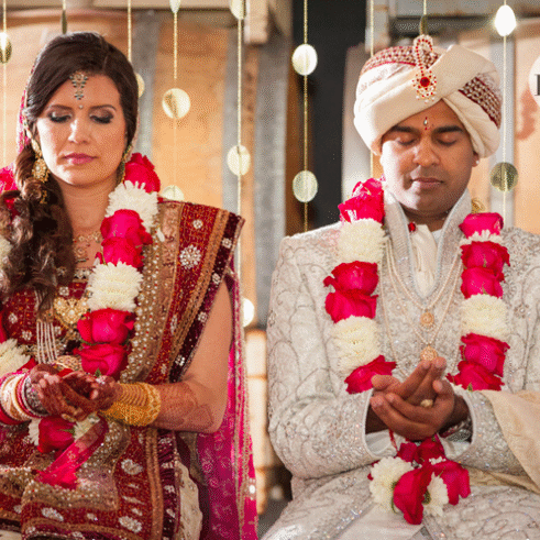 A couple of people that are in their wedding clothes