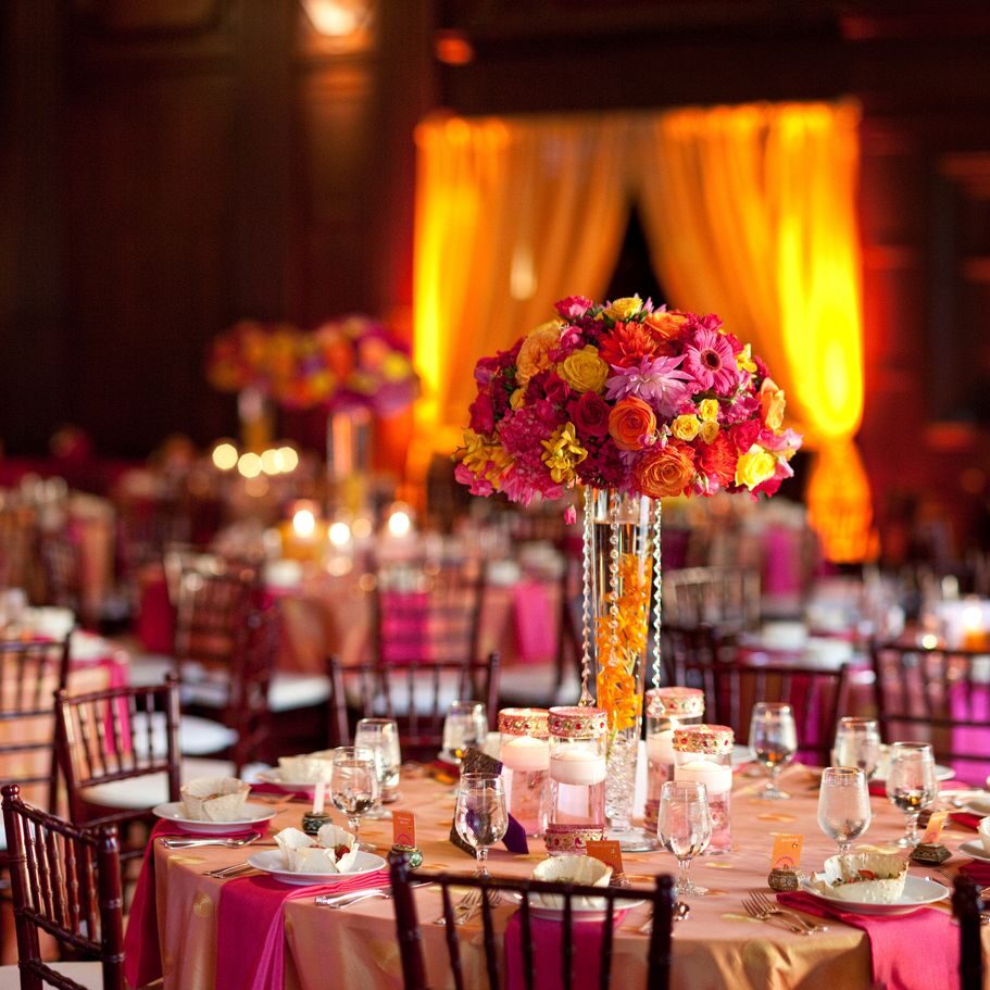 5 A table set up with pink and yellow flowers.