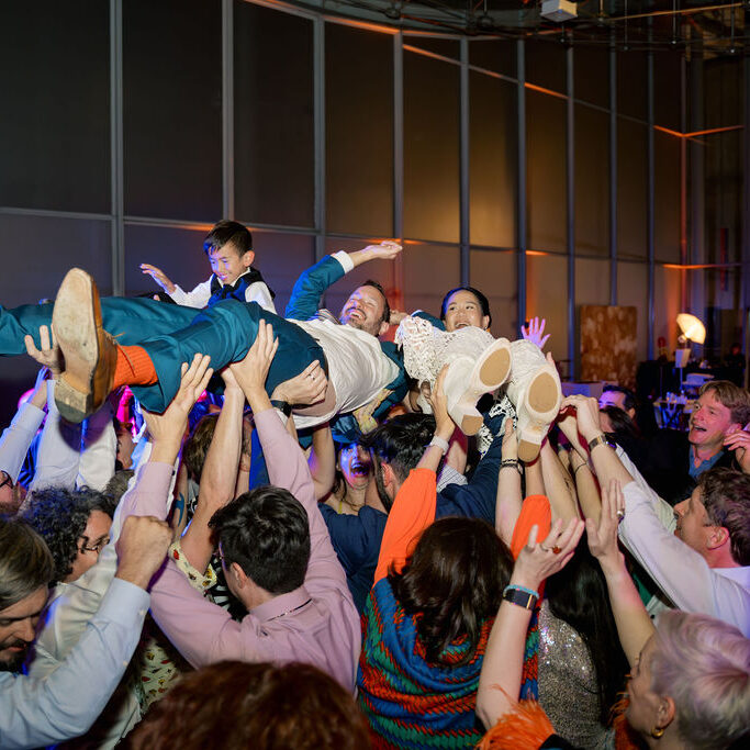 Derek&KaylaPhotography-200 A crowd of people are dancing and jumping.