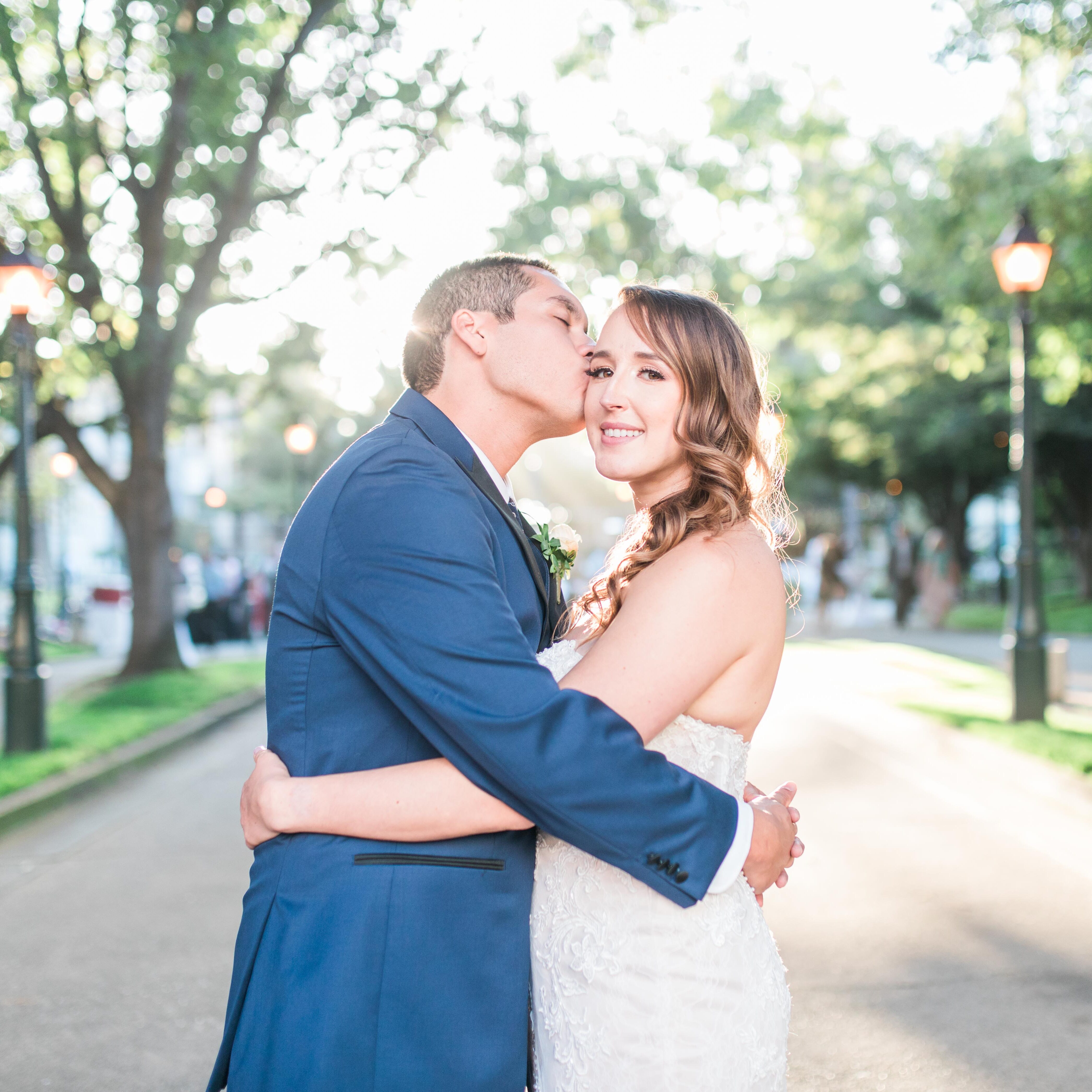A man and woman kissing on the street.