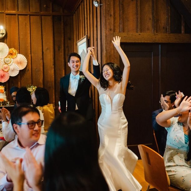 A bride and groom are dancing at their wedding.