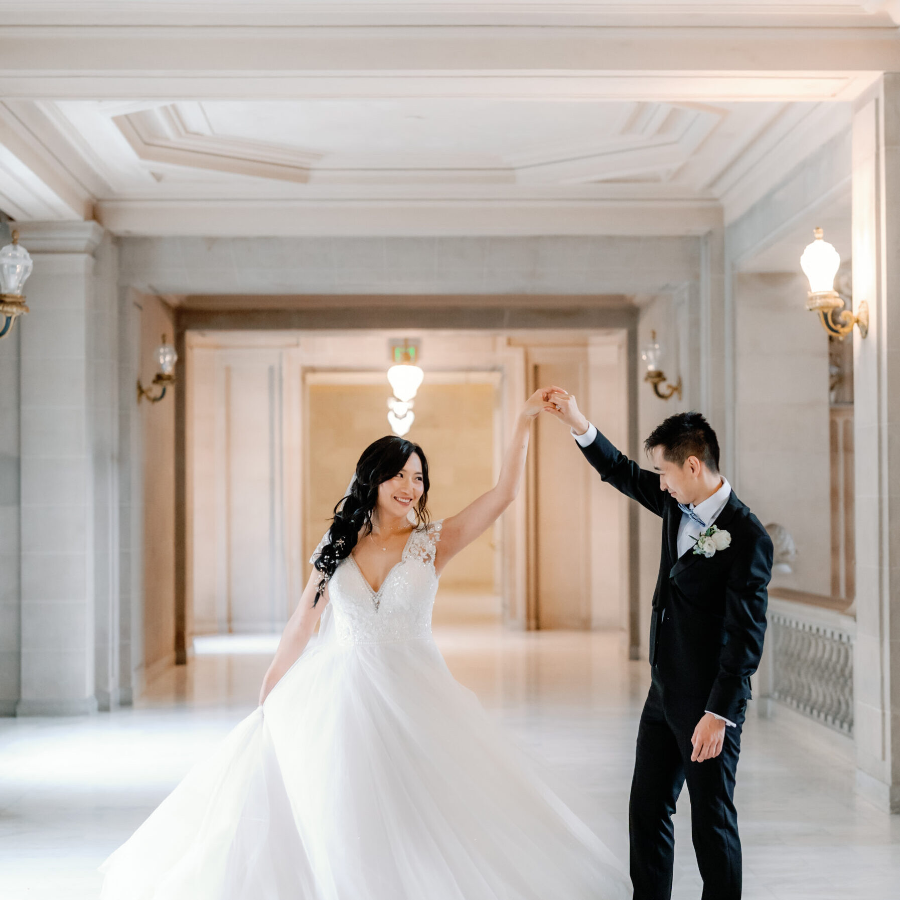 A bride and groom are dancing in the hall.